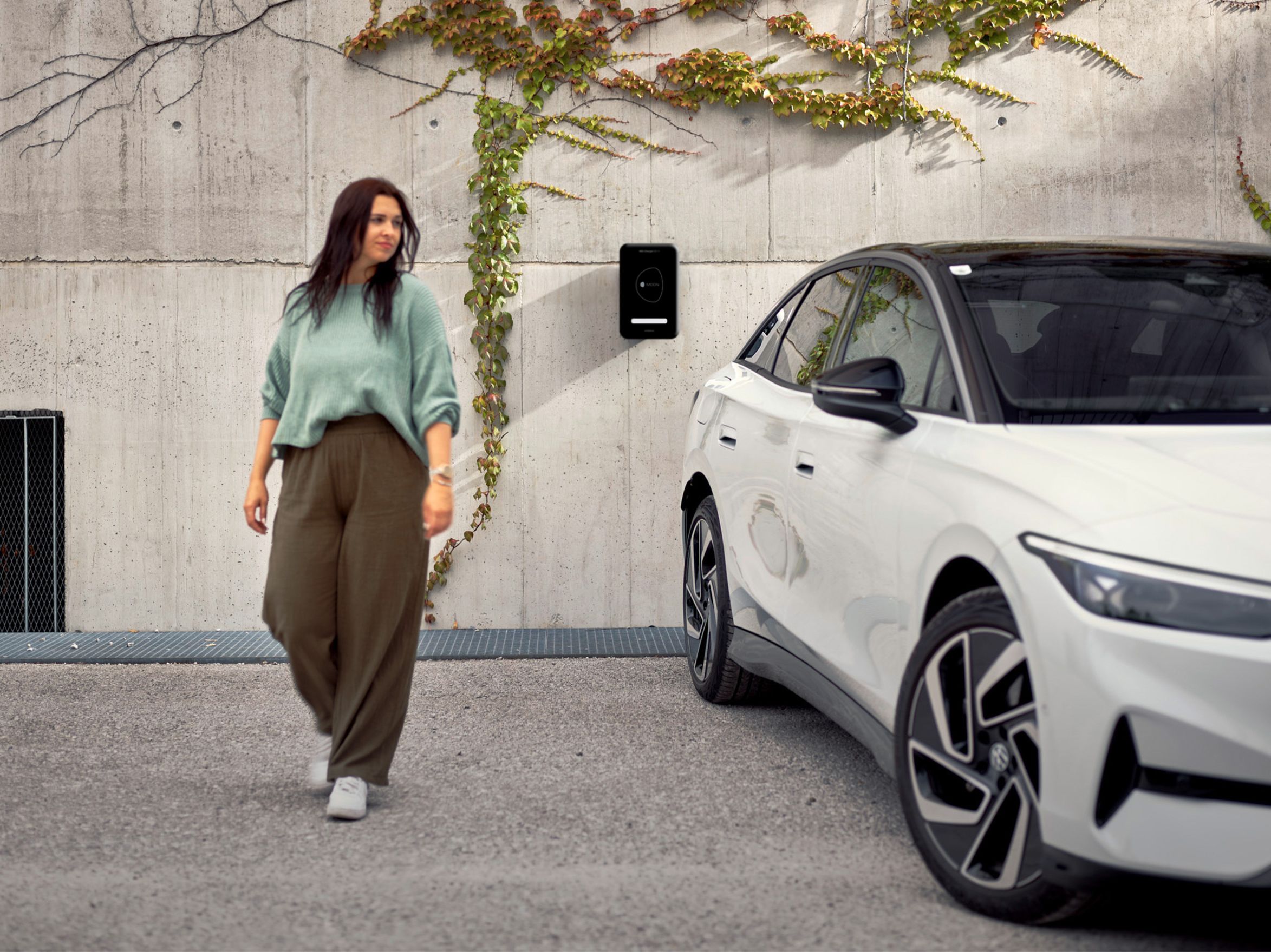 MOON POWER BiDi Charger on the wall behind a car