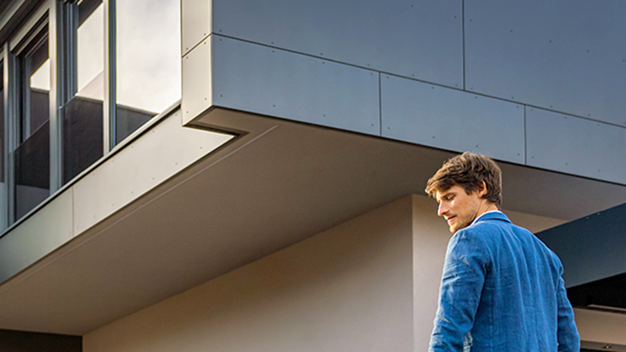 Osoba kráčí k autu s kabelem v ruce